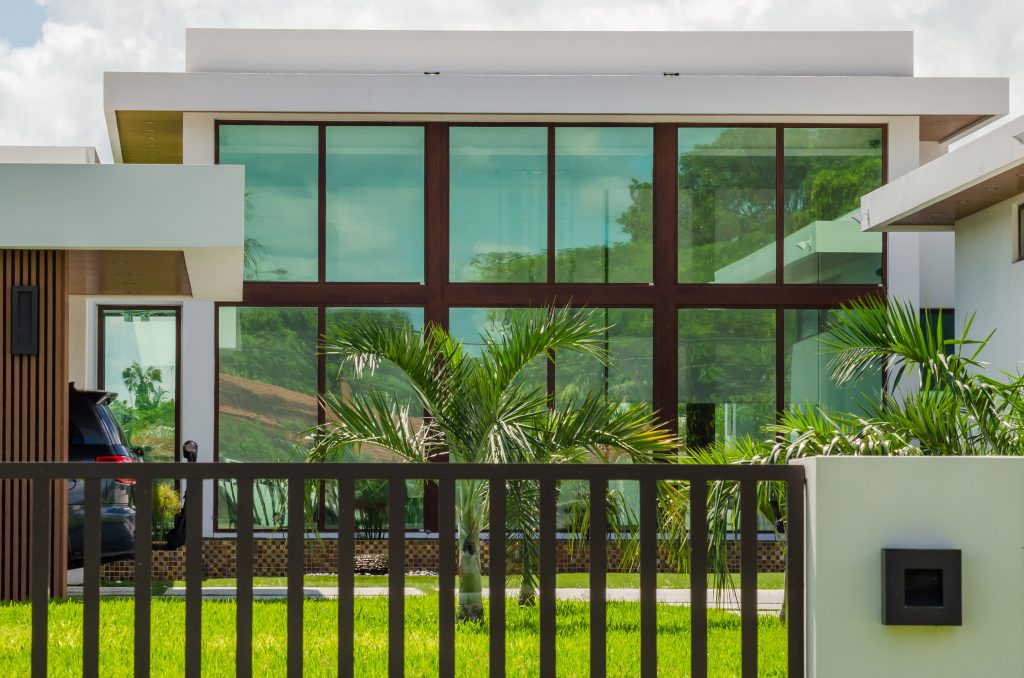 modern architectural facade with a large, symmetrical glass window structure framed in dark wood