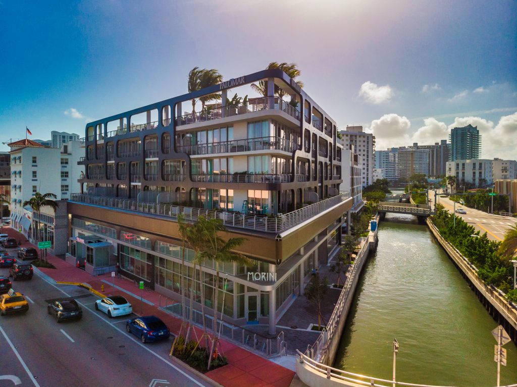 striking urban building with modern architecture situated alongside a canal