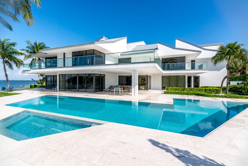 modern luxury home with sleek white walls and large glass panels