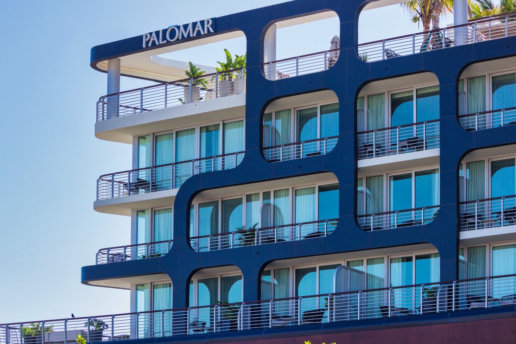 building with unique rounded rectangular cutouts framing glass balconies